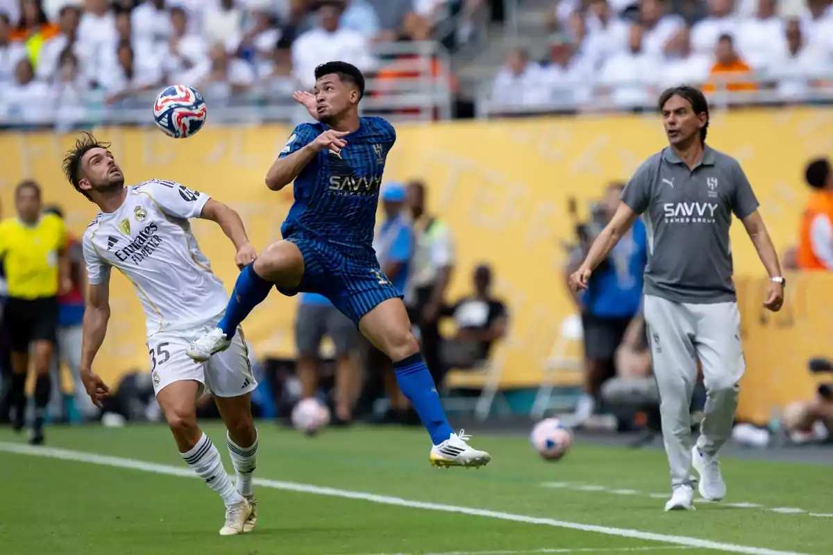 Two players contest the ball in the air during a match while a coach watches from the sideline. Two players contest the ball in the air during a match while a coach watches from the sideline.