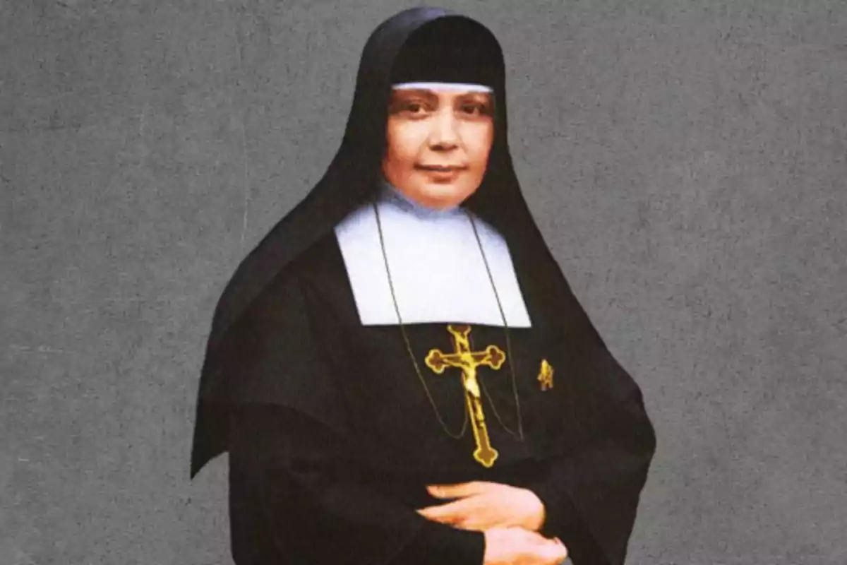 Dona vestida amb hàbit de monja negre i blanc amb un crucifix daurat sobre el pit i fons gris Dona vestida amb hàbit de monja negre i blanc amb un crucifix daurat sobre el pit i fons gris