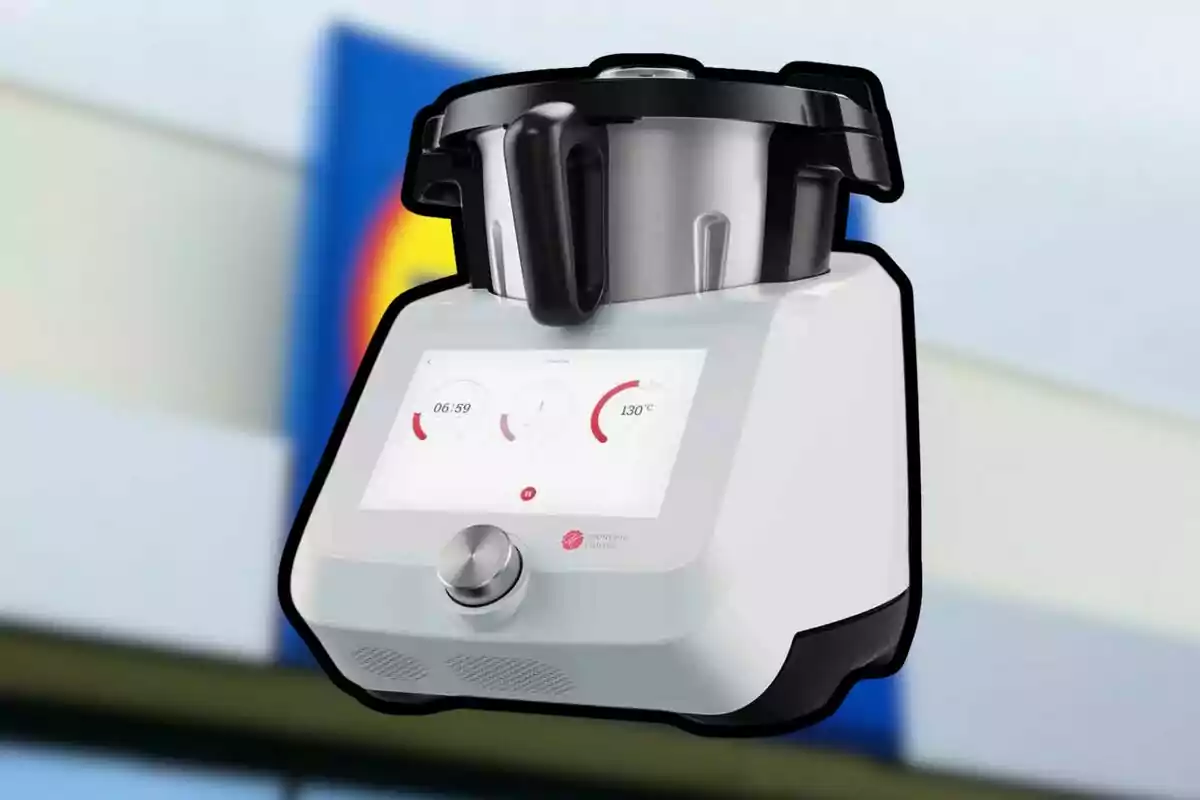 White multifunction kitchen robot with digital display and silver knob against a blurred background