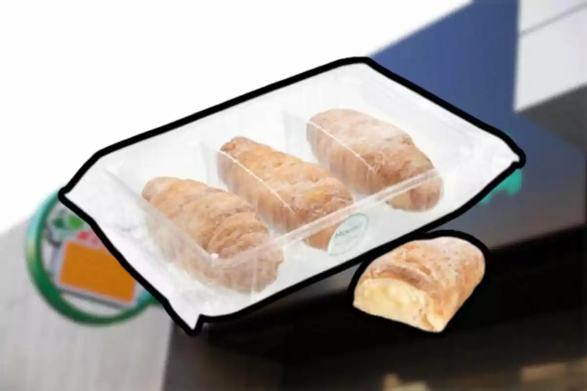 Quatre panades dolces farcides de crema pastissera en un envàs de plàstic transparent Quatre panades dolces farcides de crema pastissera en un envàs de plàstic transparent