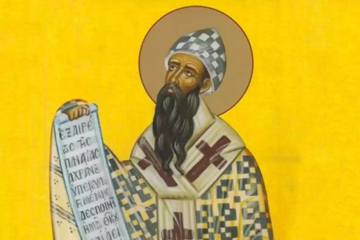 Il·lustració d’un sant ortodox amb vestimenta religiosa, barba llarga, un halo daurat i un pergamí amb text en grec sobre un fons groc