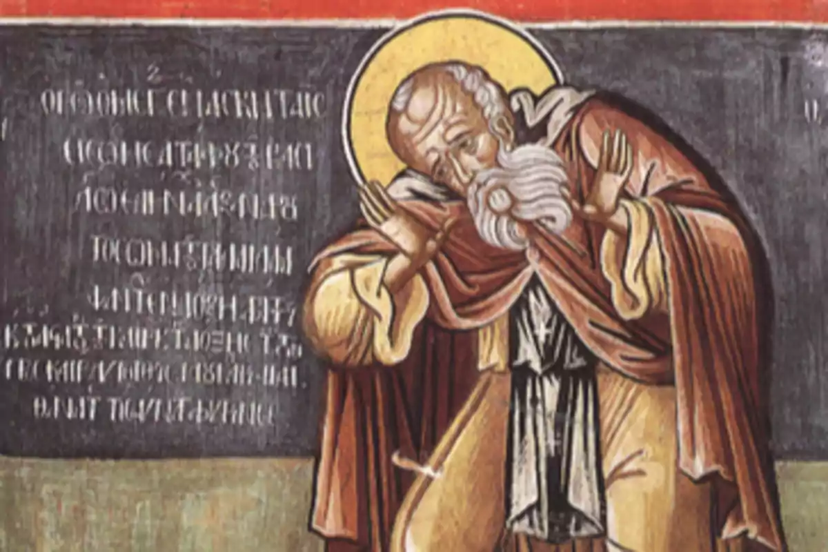 Pintura religiosa d’un home ancià amb barba blanca i halo daurat vestit amb una túnica marró i fons amb inscripcions Pintura religiosa d’un home ancià amb barba blanca i halo daurat vestit amb una túnica marró i fons amb inscripcions