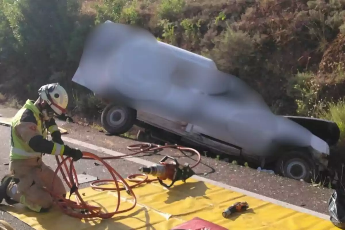 Bombarder agenollat a terra manipulant equip de rescat al costat d’un vehicle accidentat fora de la carretera a l’A-1503, a Saragossa.