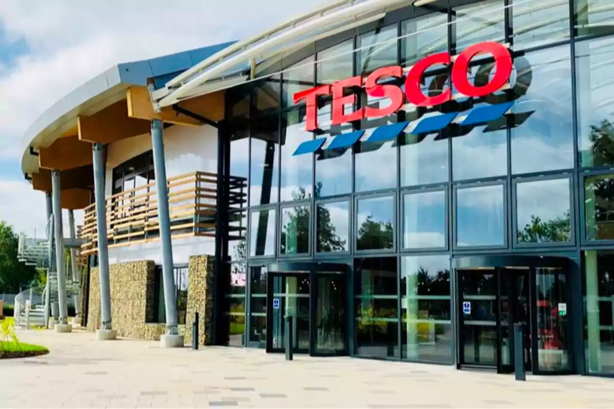 Modern facade of a Tesco store with large windows and a visible main entrance