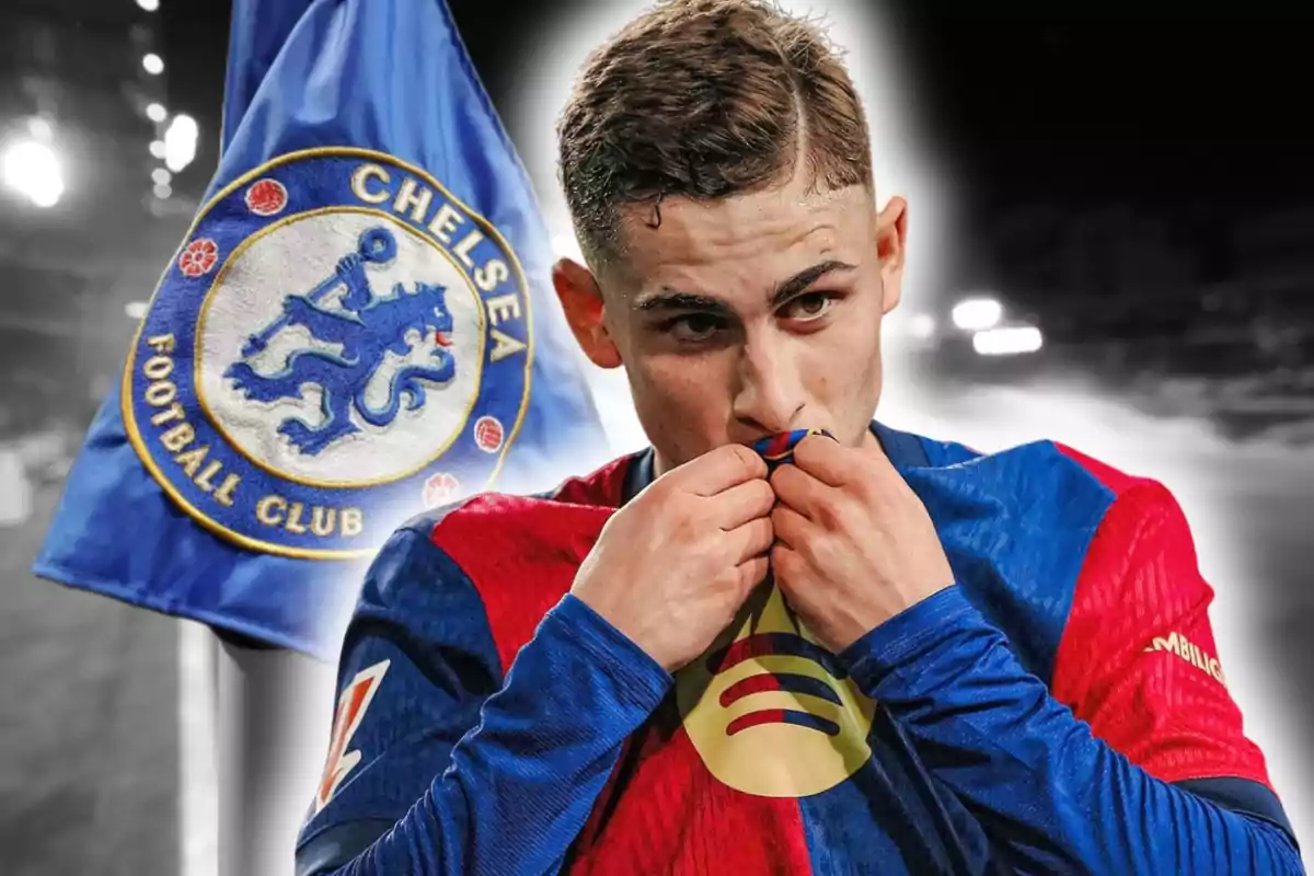A player kisses the badge on his Barcelona jersey while a Chelsea Football Club flag appears in the background.