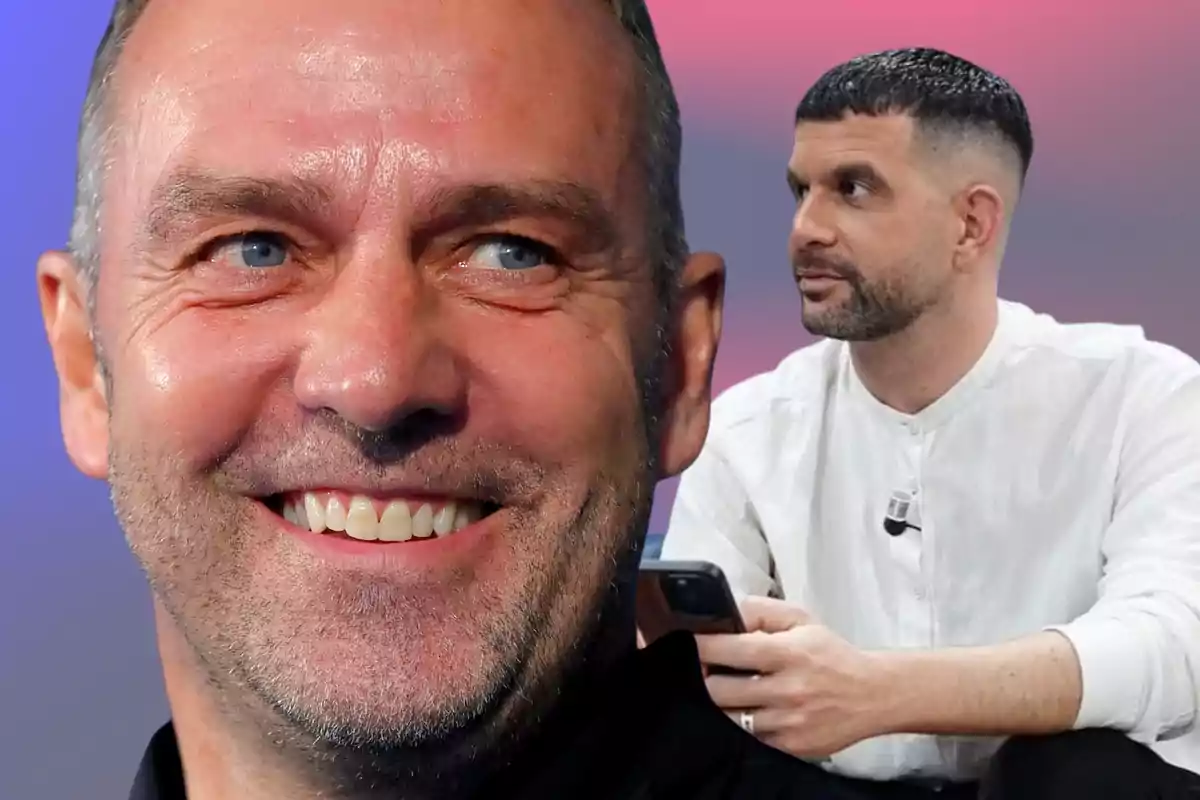 Close-up of a smiling man with a beard and blue eyes in the foreground, and another man with short hair and a trimmed beard sitting in the background holding a phone, against a pink and blue gradient background.
