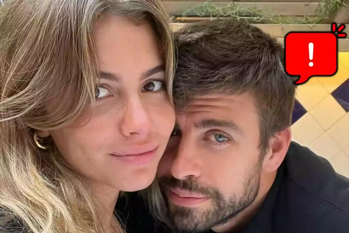 Parella jove —formada per Clara Chía i Gerard Piqué— posant junts amb una bombolla vermella d’advertència a la cantonada superior dreta.