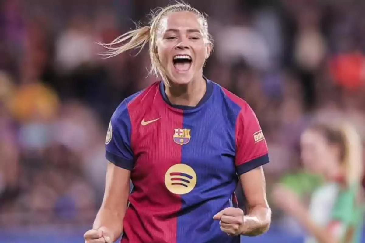 Barcelona women's player celebrating a goal with an expression of joy and excitement on the field Barcelona women's player celebrating a goal with an expression of joy and excitement on the field