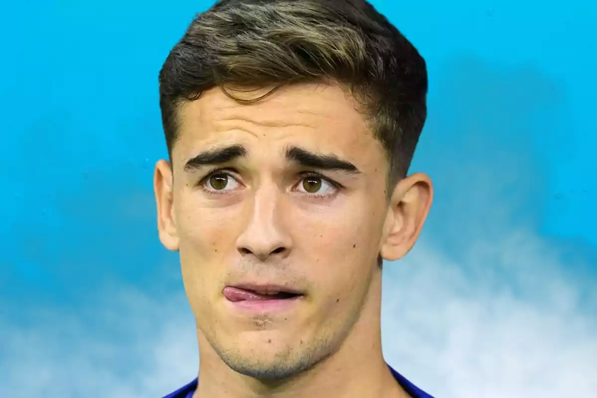 Young man with a thoughtful expression and a blue background