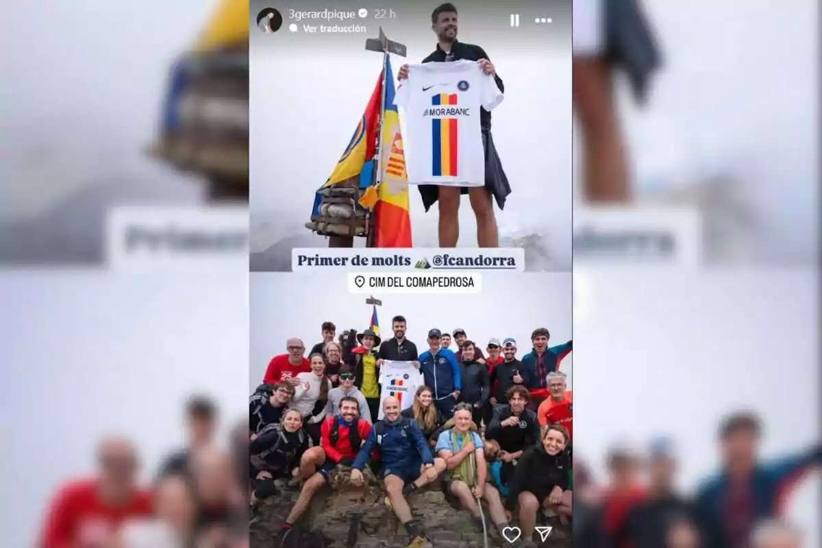 A man holds a soccer jersey next to a flag at the top of a mountain, surrounded by a group of smiling people. A man holds a soccer jersey next to a flag at the top of a mountain, surrounded by a group of smiling people.
