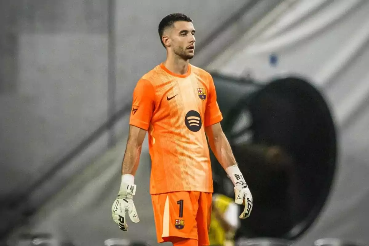 Barcelona goalkeeper wearing an orange uniform with white gloves in a stadium Barcelona goalkeeper wearing an orange uniform with white gloves in a stadium