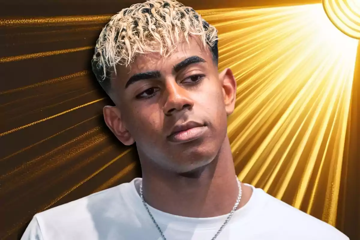 Young man with curly blonde and dark hair looking down with a background of golden rays