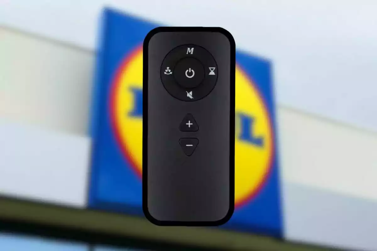 Black remote control with several buttons in the foreground and a blurred Lidl store logo in the background Black remote control with several buttons in the foreground and a blurred Lidl store logo in the background