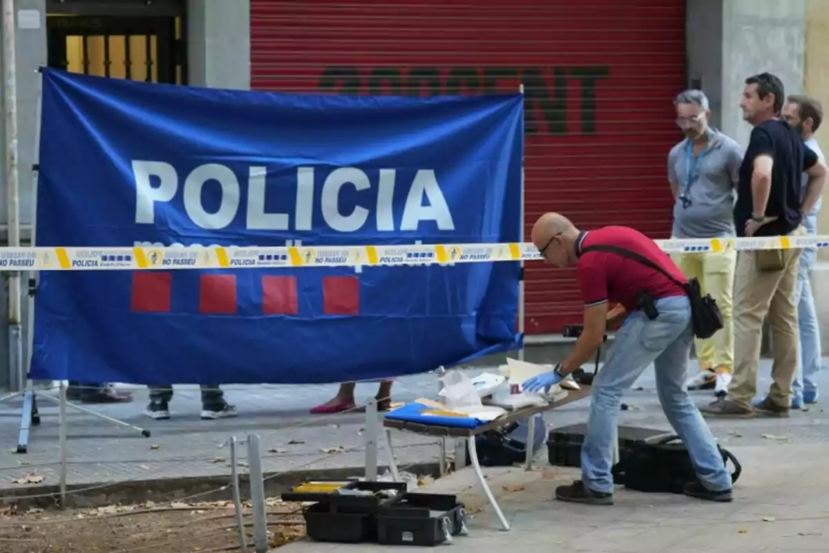 An agent conducts investigative work at a scene cordoned off by the police while several people watch from behind a security tape. An agent conducts investigative work at a scene cordoned off by the police while several people watch from behind a security tape.