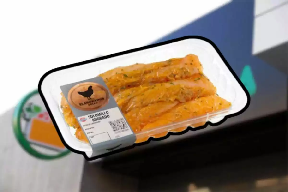 Tray of marinated chicken tenderloin packaged with a label against a blurred supermarket background Tray of marinated chicken tenderloin packaged with a label against a blurred supermarket background