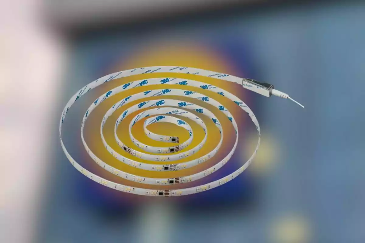 Spiral-wrapped LED light strip against a blurred blue and yellow background Spiral-wrapped LED light strip against a blurred blue and yellow background