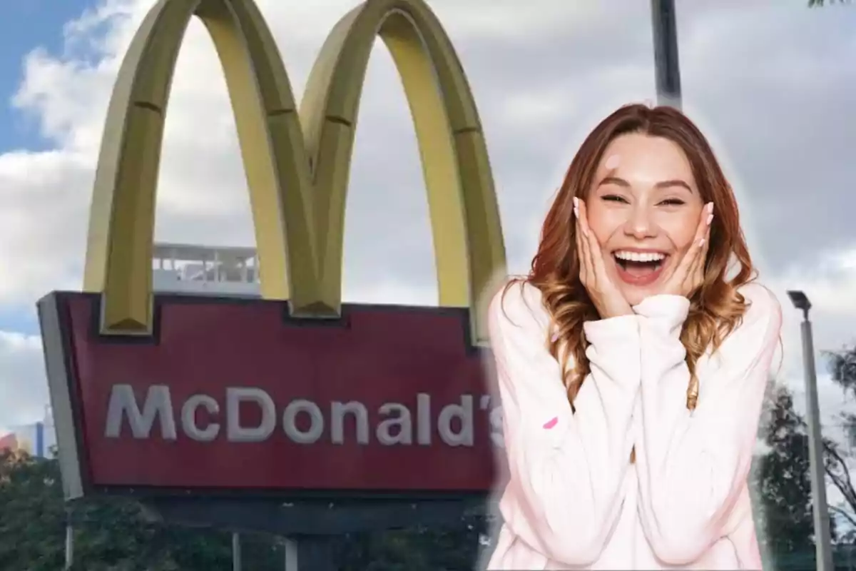 A smiling woman with her hands on her face is standing in front of a McDonald's sign.