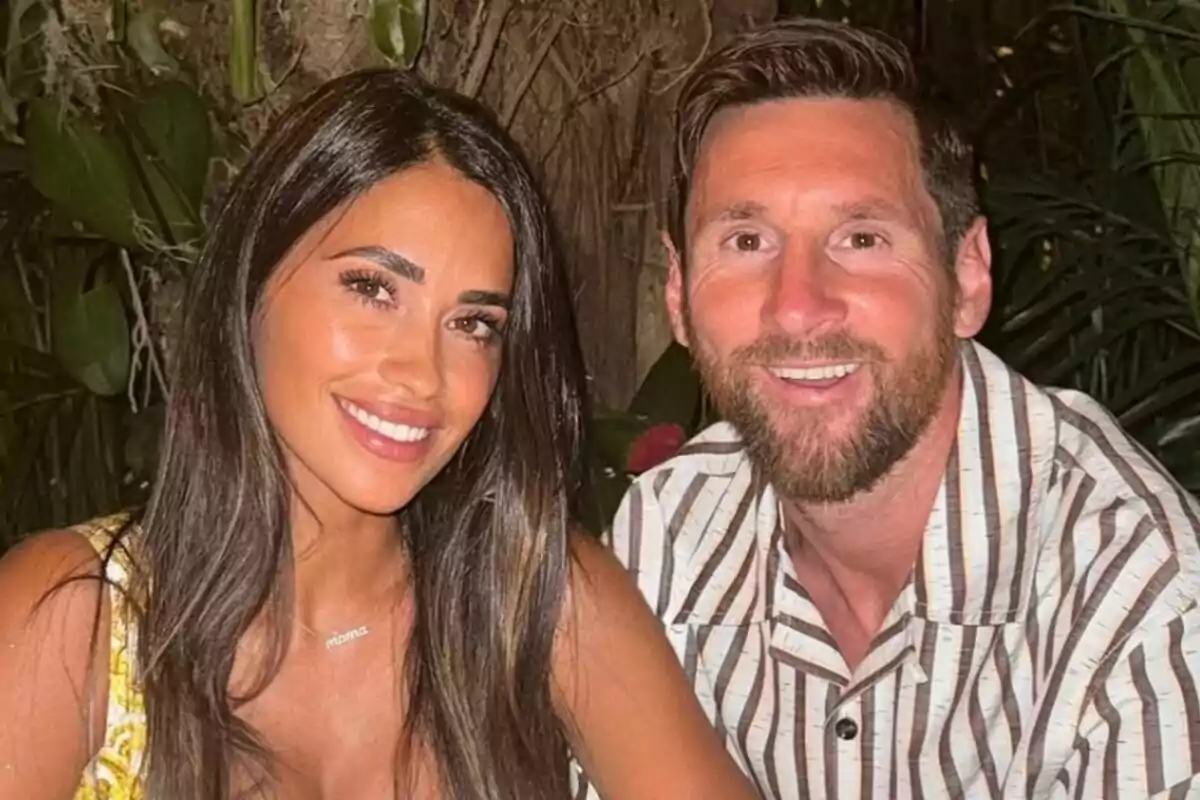 A couple smiles while posing for a photo in a natural setting with plants in the background. A couple smiles while posing for a photo in a natural setting with plants in the background.
