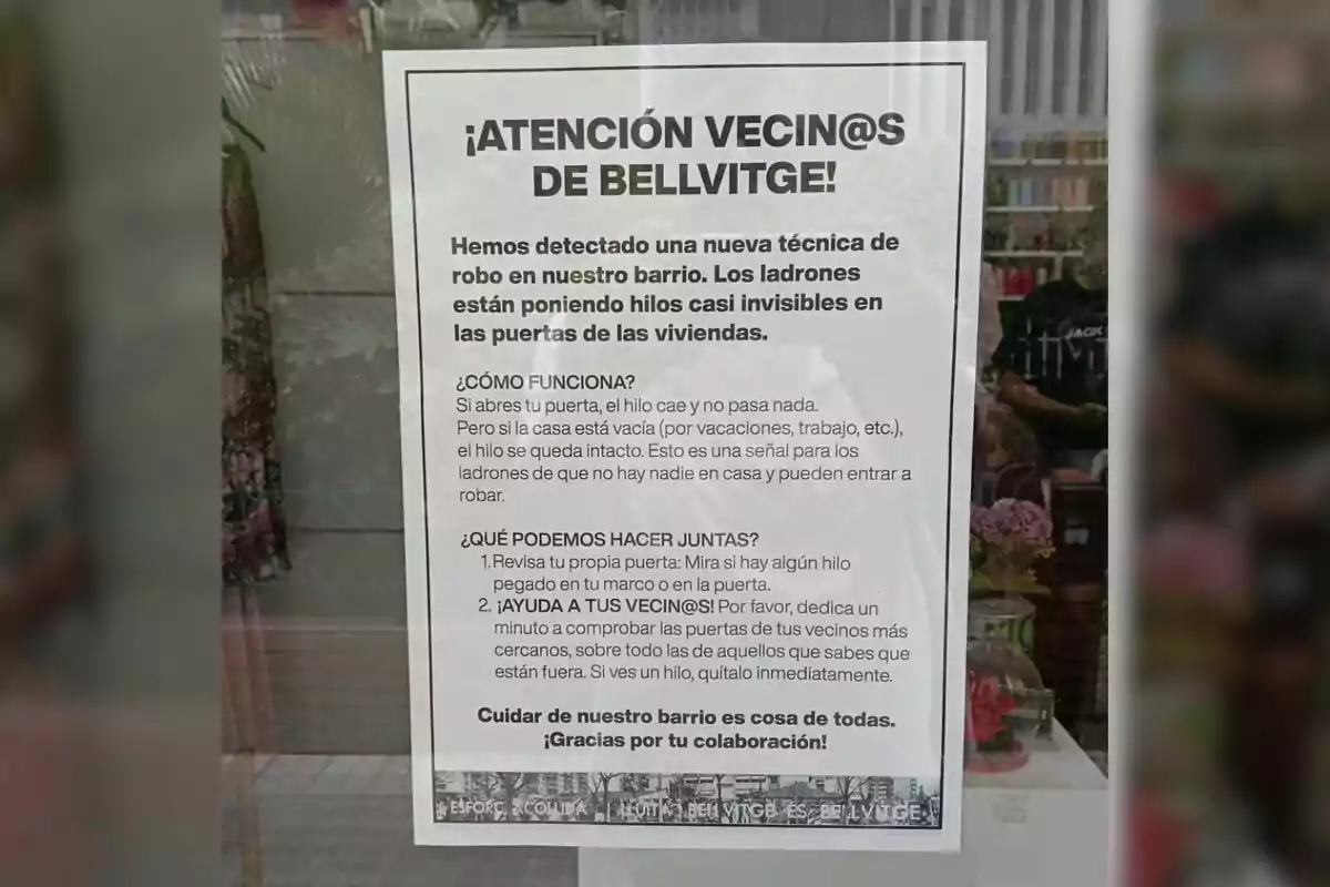 Informational poster stuck on a glass door warning the residents of Bellvitge about a new burglary technique in which thieves place almost invisible threads on doors to find out if a home is unoccupied, and encouraging people to check the doors and help their neighbors. Informational poster stuck on a glass door warning the residents of Bellvitge about a new burglary technique in which thieves place almost invisible threads on doors to find out if a home is unoccupied, and encouraging people to check the doors and help their neighbors.