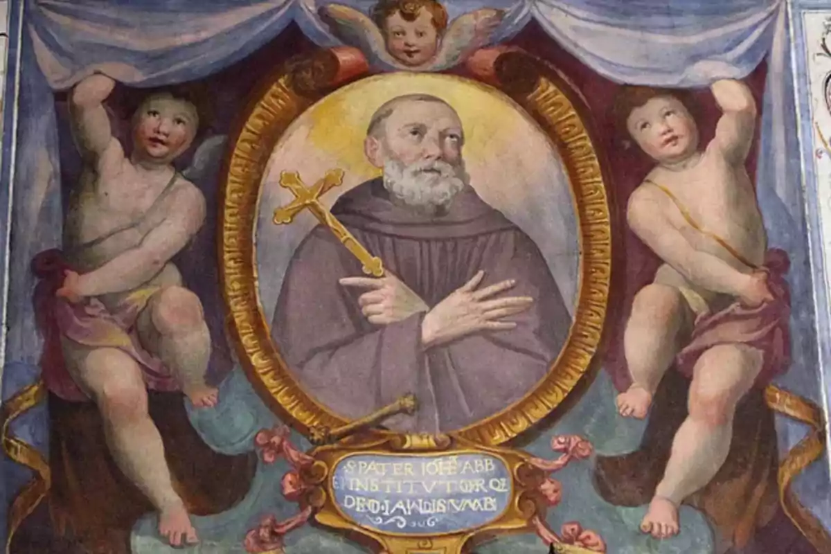 Pintura religiosa d’un frare amb barba i hàbit sostenint una creu daurada envoltat de querubins i un marc oval decoratiu