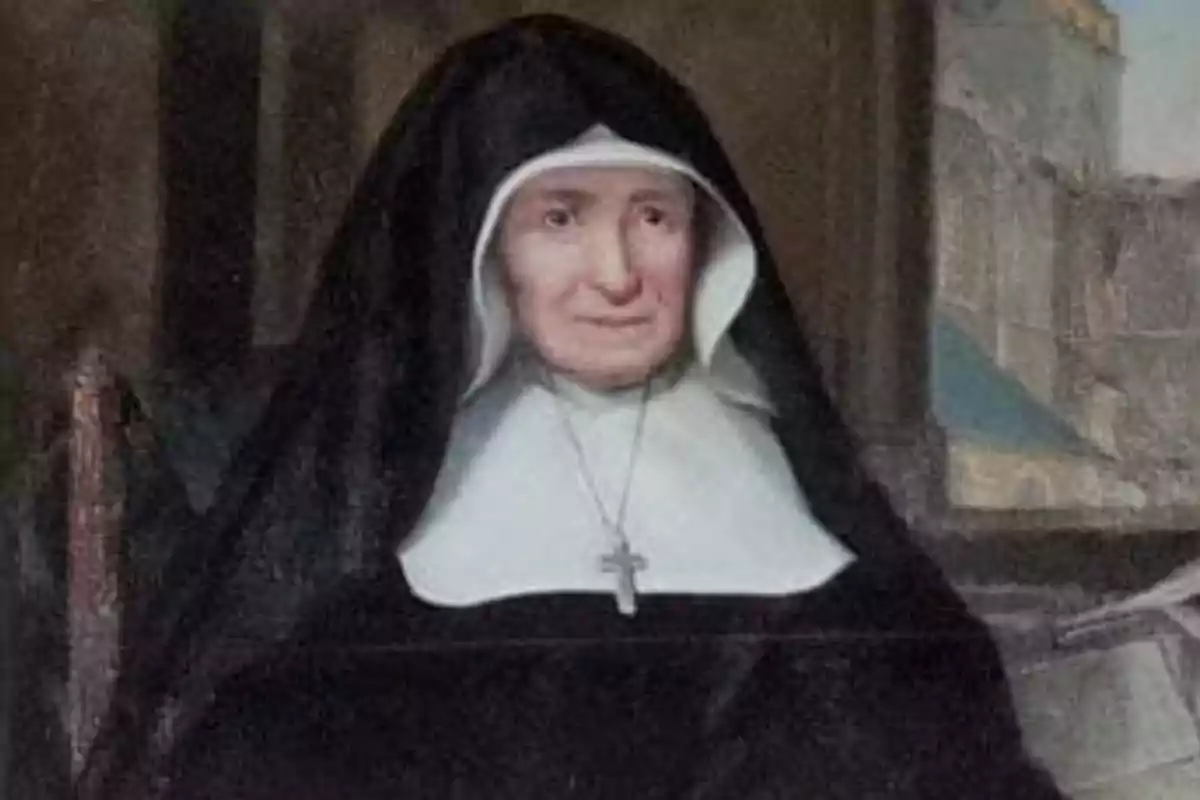 Dona gran vestida amb hàbit religiós negre i blanc, asseguda i portant un crucifix al coll Dona gran vestida amb hàbit religiós negre i blanc, asseguda i portant un crucifix al coll