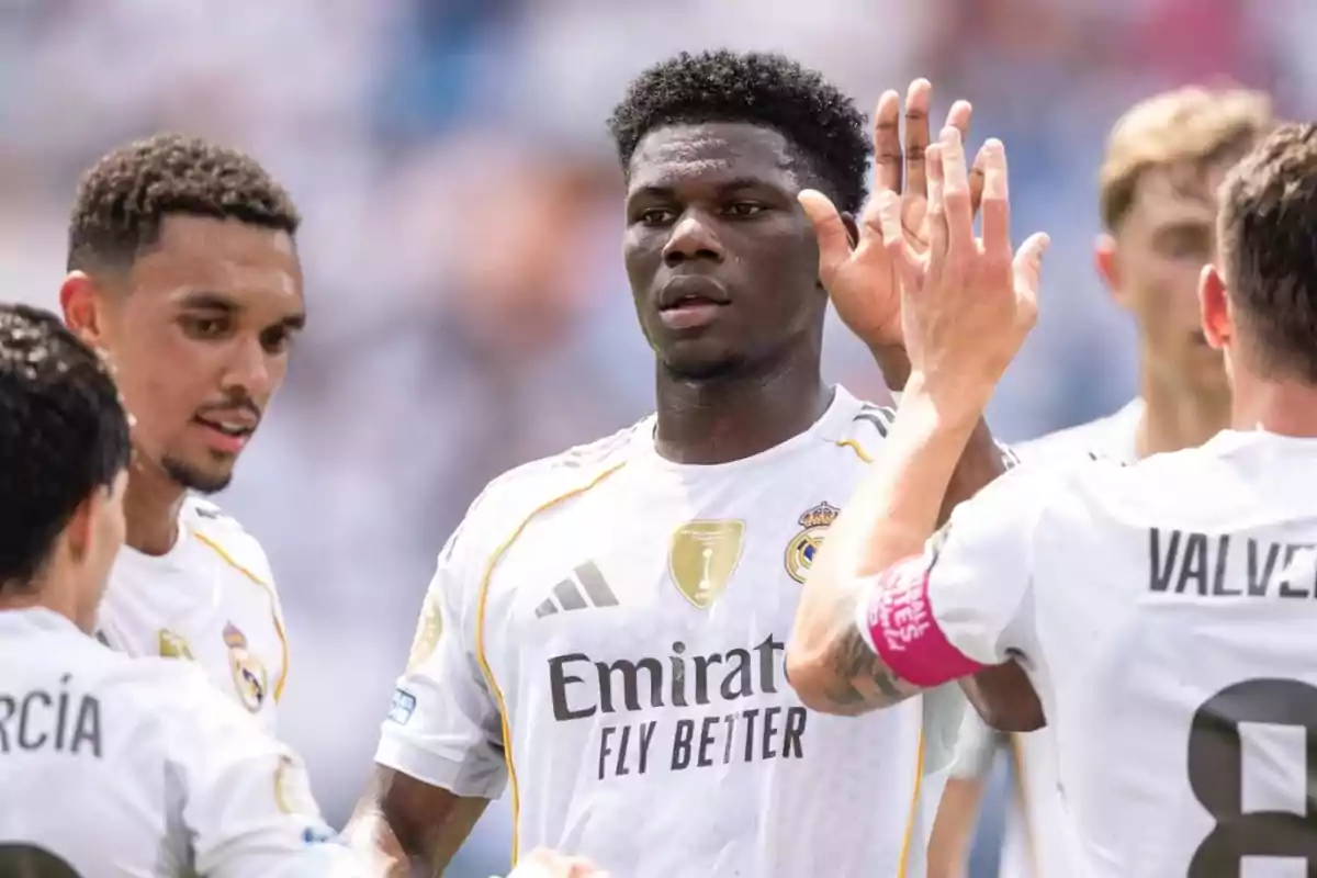 Real Madrid players celebrate together during a soccer match Real Madrid players celebrate together during a soccer match