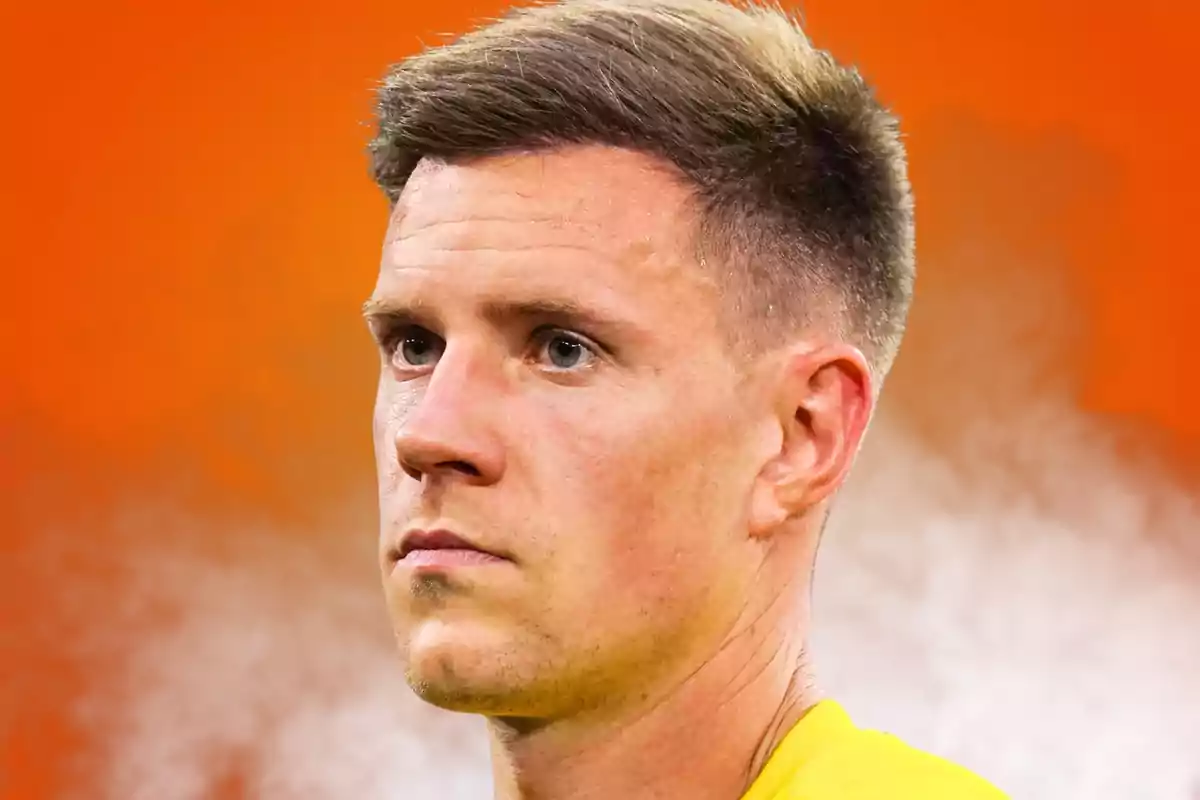 Short-haired blond man with a serious expression against a blurred orange background