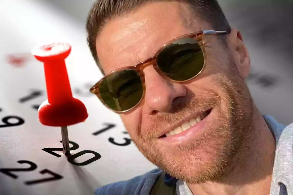 Smiling man with sunglasses in front of a calendar marked with a red pushpin on the 20th.