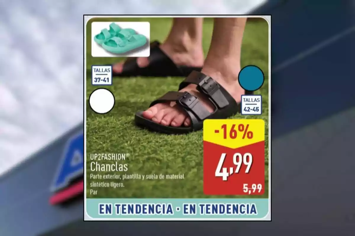 Persona amb sandàlies negres de dues tires sobre gespa artificial amb oferta de 4,99 euros i descompte del 16 per cent, disponibles en talles del 37 al 46 i en colors blanc, negre i verd aqua. Persona amb sandàlies negres de dues tires sobre gespa artificial amb oferta de 4,99 euros i descompte del 16 per cent, disponibles en talles del 37 al 46 i en colors blanc, negre i verd aqua.