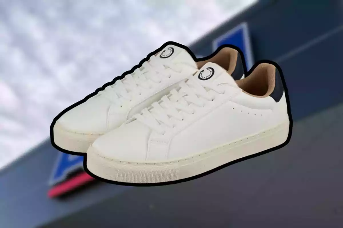 Un par de tenis blancos con detalles en negro y fondo desenfocado Un par de tenis blancos con detalles en negro y fondo desenfocado