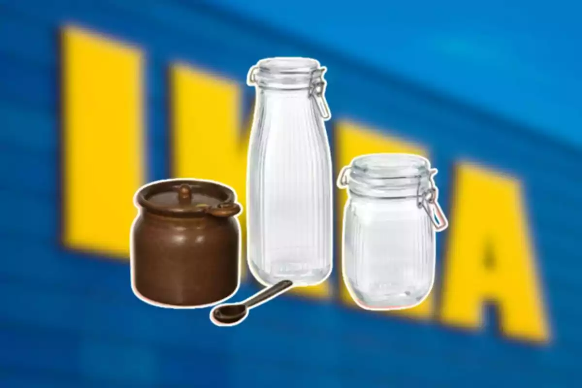 Three kitchen jars, one brown ceramic with a spoon and two glass ones with airtight lids, on a blurred blue and yellow background Three kitchen jars, one brown ceramic with a spoon and two glass ones with airtight lids, on a blurred blue and yellow background