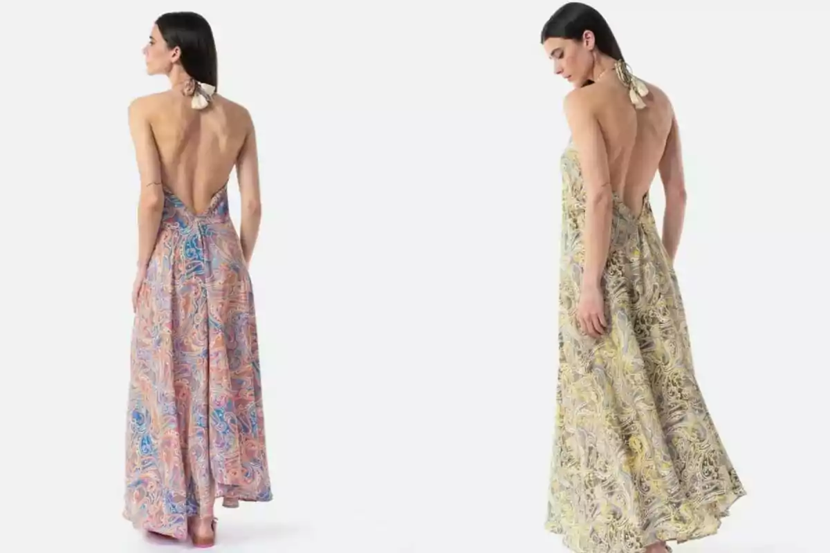 Dona d’esquena modelant dos vestits llargs amb estampat colorit i escot profund a l’esquena Dona d’esquena modelant dos vestits llargs amb estampat colorit i escot profund a l’esquena