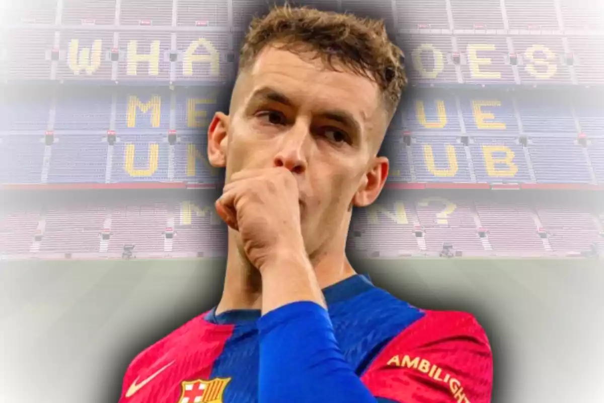 Barcelona player celebrating with a closed fist in front of his mouth in an empty stadium with stands displaying a message in English
