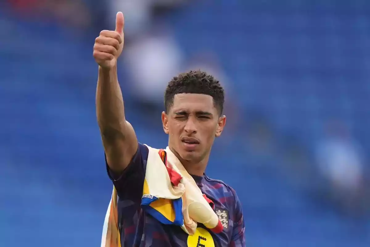 Soccer player giving a thumbs up and winking in a stadium Soccer player giving a thumbs up and winking in a stadium