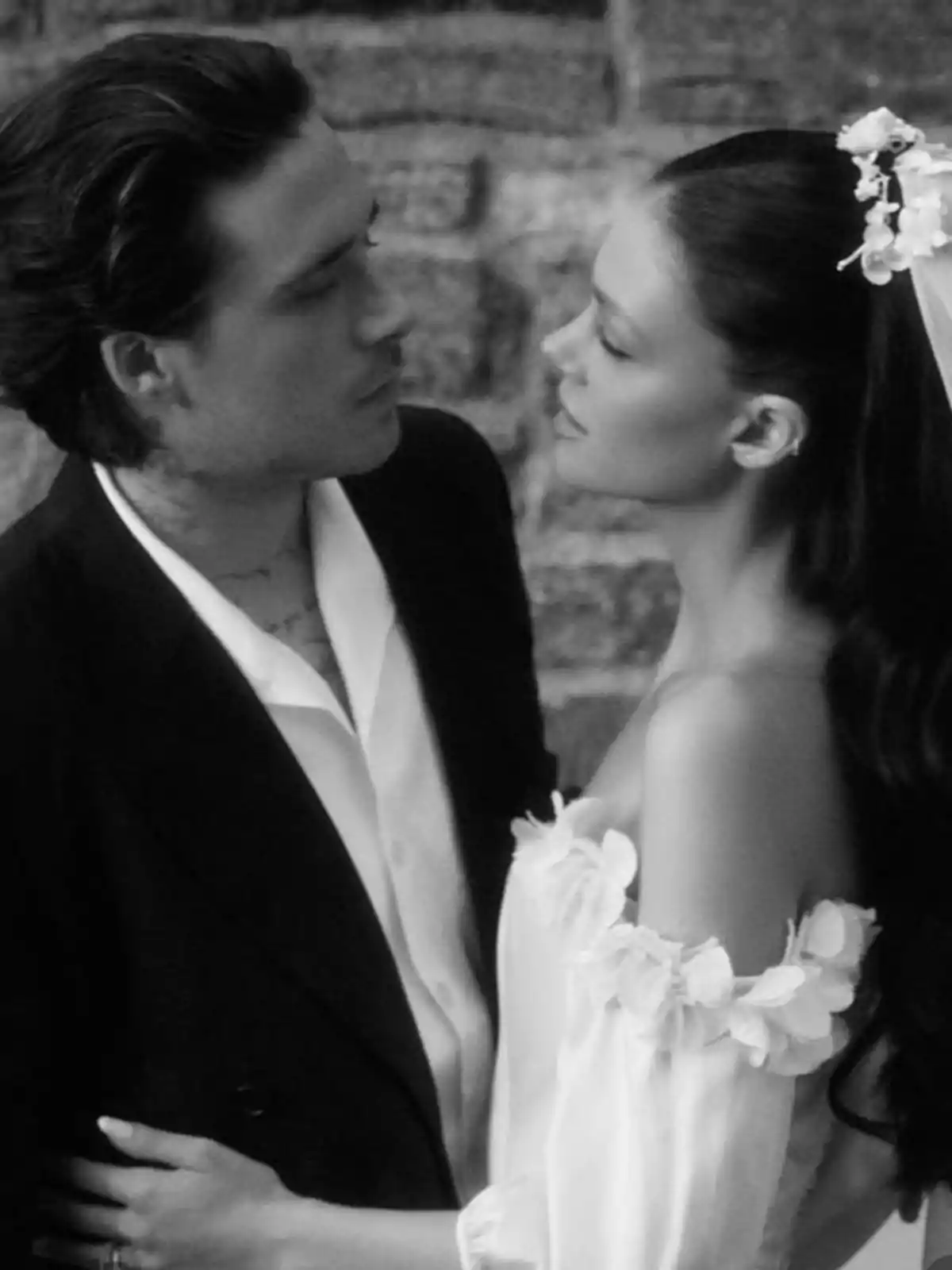 Elegantly dressed couple looking at each other tenderly in a black and white photograph Elegantly dressed couple looking at each other tenderly in a black and white photograph