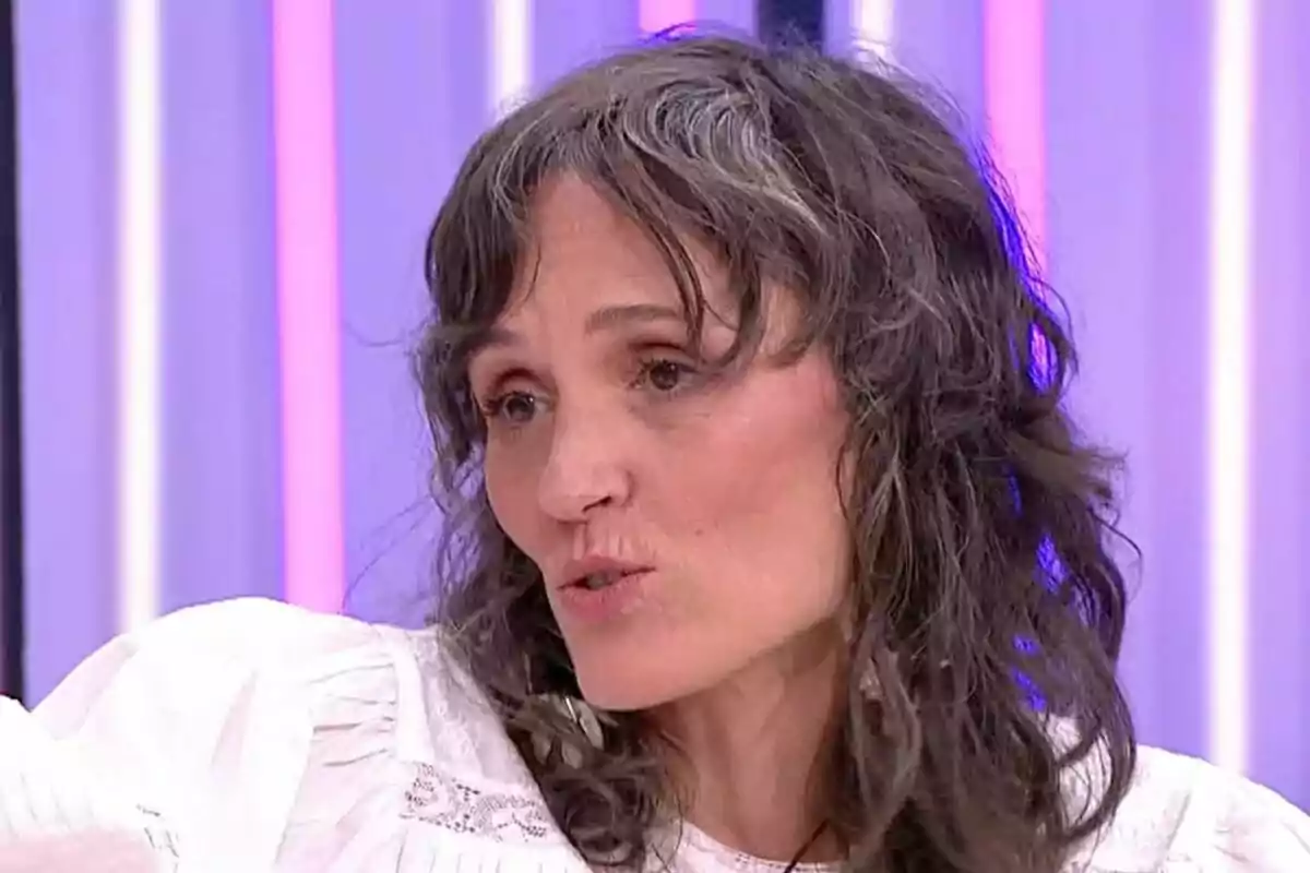 Laura Pamplona de cabello ondulado y canoso con blusa blanca hablando en un set de Y ahora Sonsoles con luces de colores en el fondo Laura Pamplona de cabello ondulado y canoso con blusa blanca hablando en un set de Y ahora Sonsoles con luces de colores en el fondo