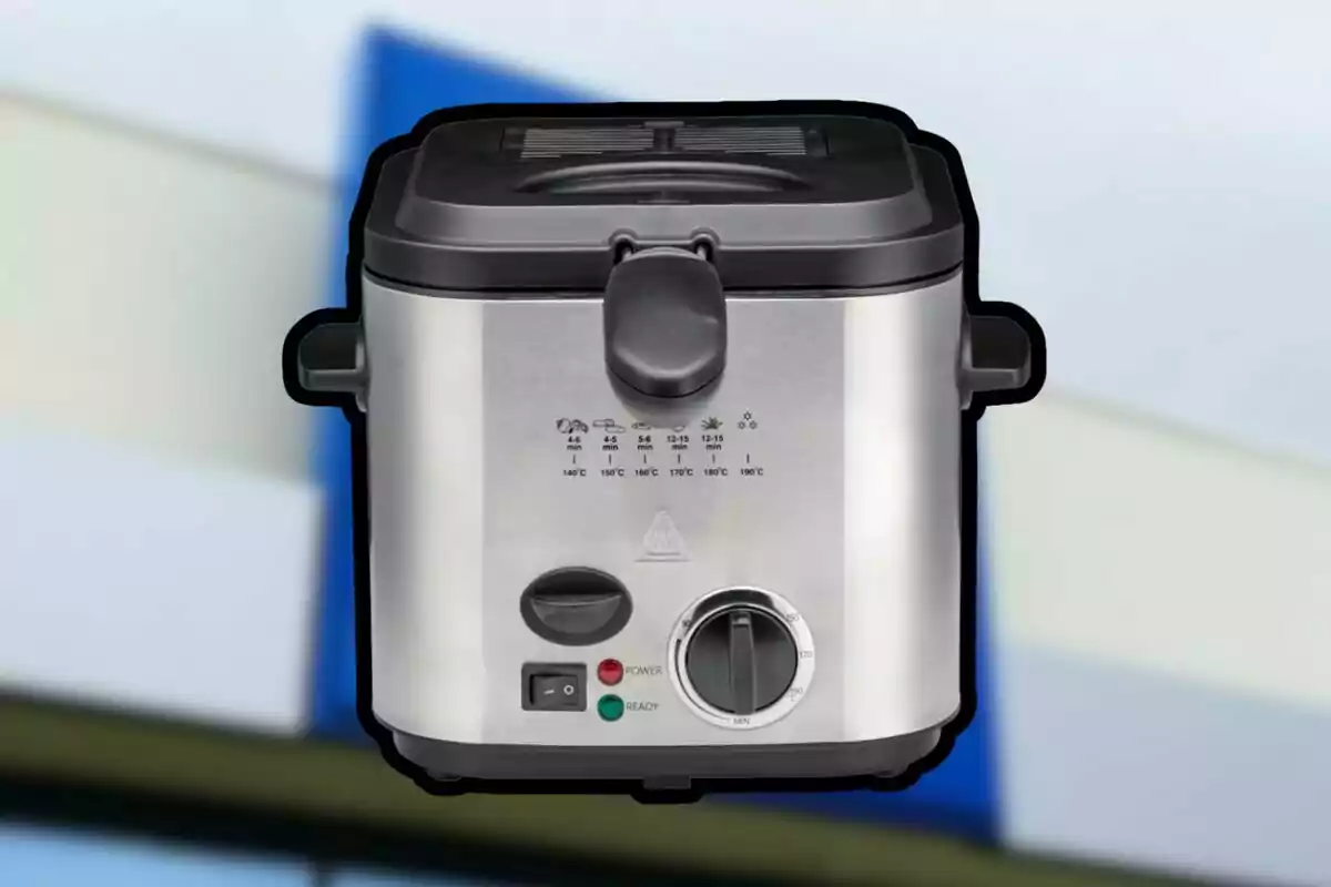 Stainless steel electric fryer with front controls and blurred background Stainless steel electric fryer with front controls and blurred background