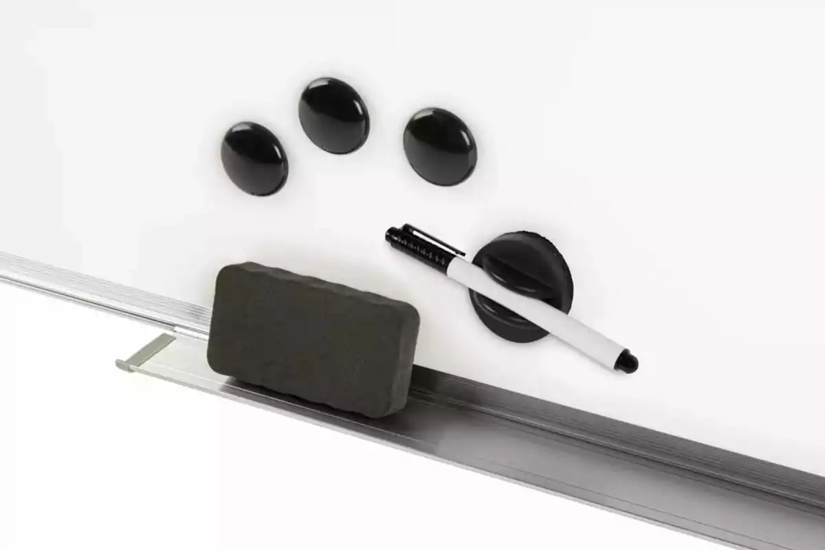 Whiteboard with three black magnets, an eraser, and a marker held by a magnetic holder Whiteboard with three black magnets, an eraser, and a marker held by a magnetic holder
