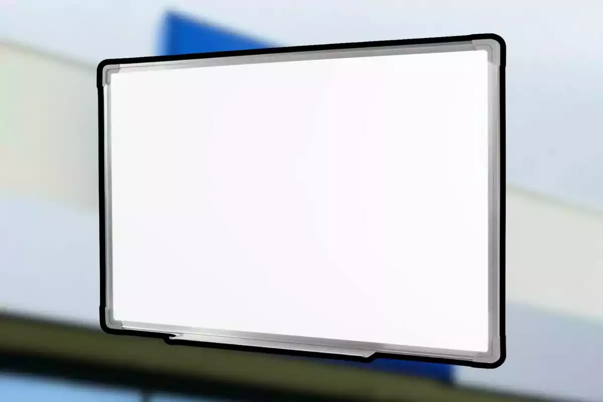 Empty whiteboard with black frame on a blurred background Empty whiteboard with black frame on a blurred background