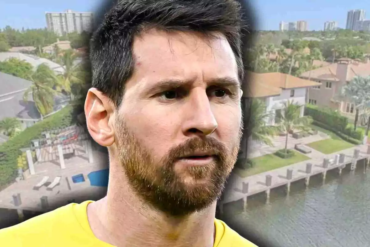 Leo Messi with a serious expression in the foreground with houses and palm trees in the background next to a water canal
