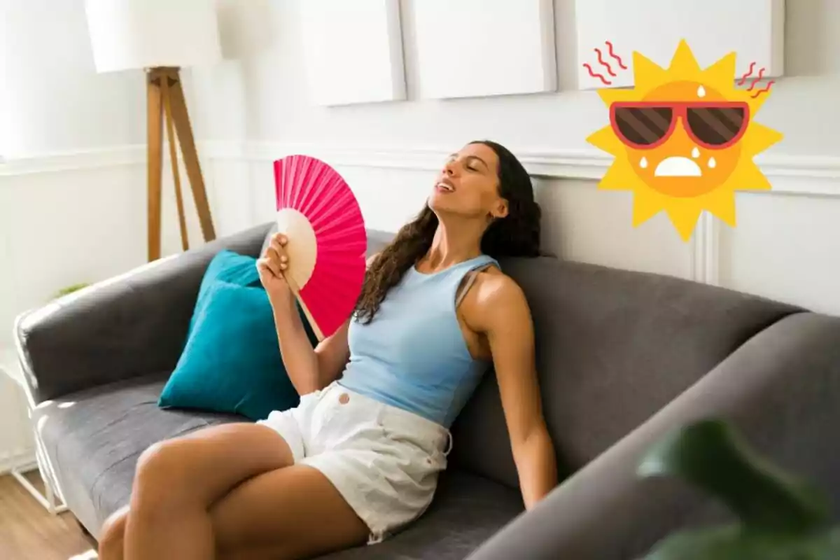 Mujer sentada en un sofá abanicándose con expresión de calor y un dibujo de sol con gafas y gotas de sudor en el fondo Mujer sentada en un sofá abanicándose con expresión de calor y un dibujo de sol con gafas y gotas de sudor en el fondo