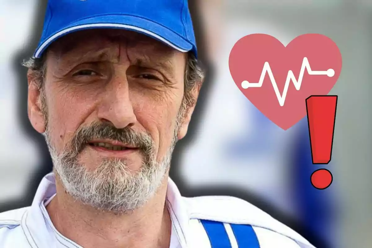 José Luis Gil con gorra azul con un ícono de corazón y un signo de exclamación rojo a su lado indicando una posible alerta de salud