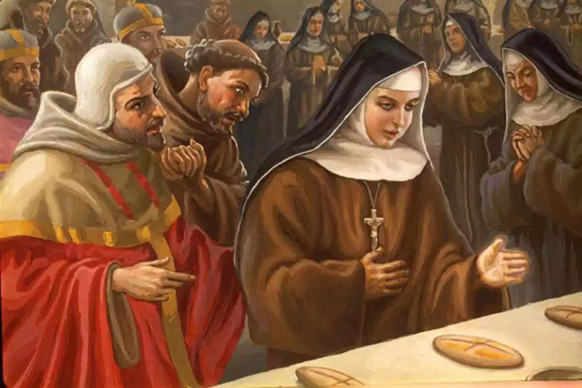 Monja amb hàbit marró i creu al pit davant d’una taula amb pans envoltada de religiosos i persones resant al fons Monja amb hàbit marró i creu al pit davant d’una taula amb pans envoltada de religiosos i persones resant al fons