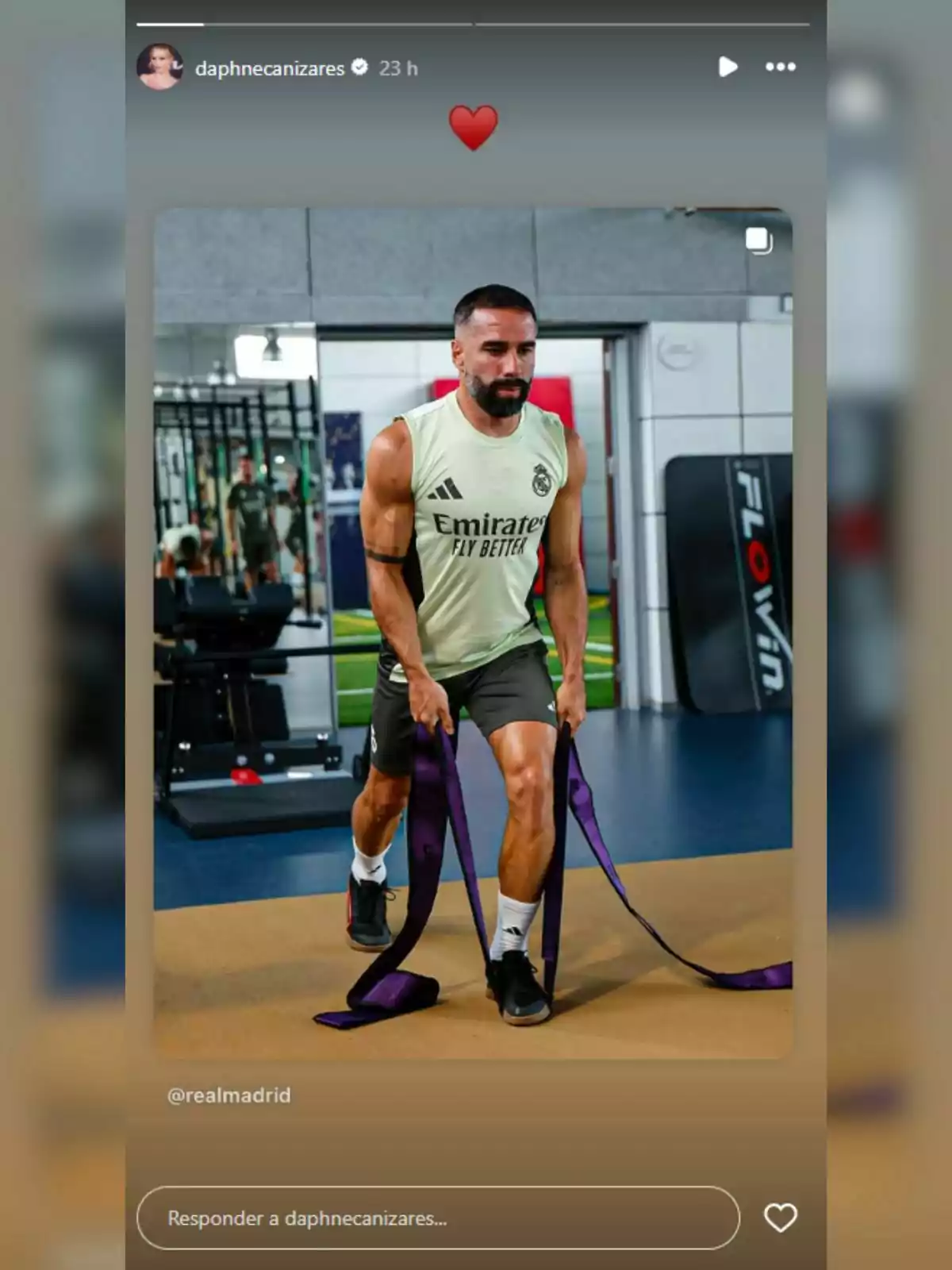 Carvajal training in a gym wearing a sleeveless Real Madrid jersey while holding purple resistance bands Carvajal training in a gym wearing a sleeveless Real Madrid jersey while holding purple resistance bands
