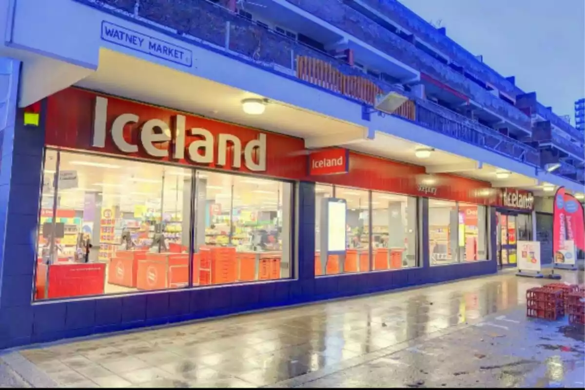 Facade of an Iceland store on a shopping street with wet sidewalks and visible signs Facade of an Iceland store on a shopping street with wet sidewalks and visible signs