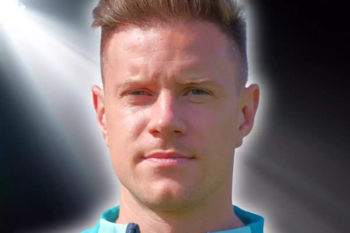 Portrait of a young man with short blond hair, dark background with a diagonal beam of white light