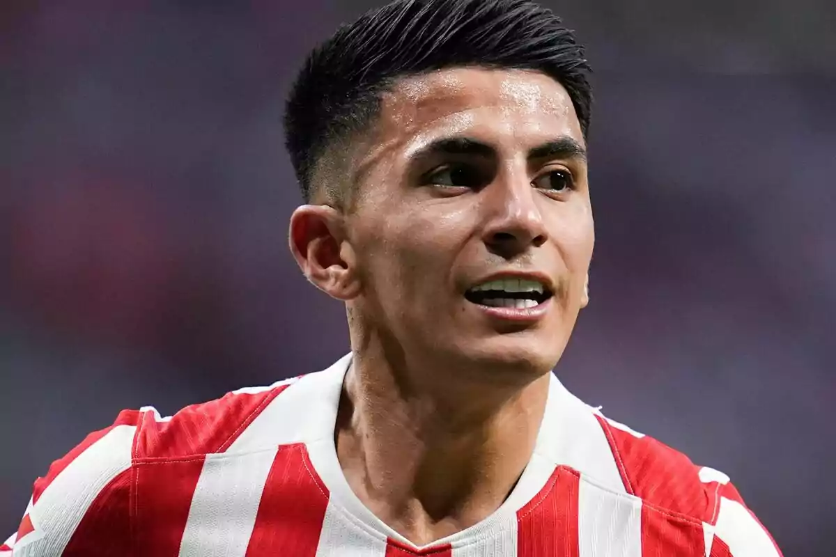 Soccer player in a red and white striped uniform during a match Soccer player in a red and white striped uniform during a match