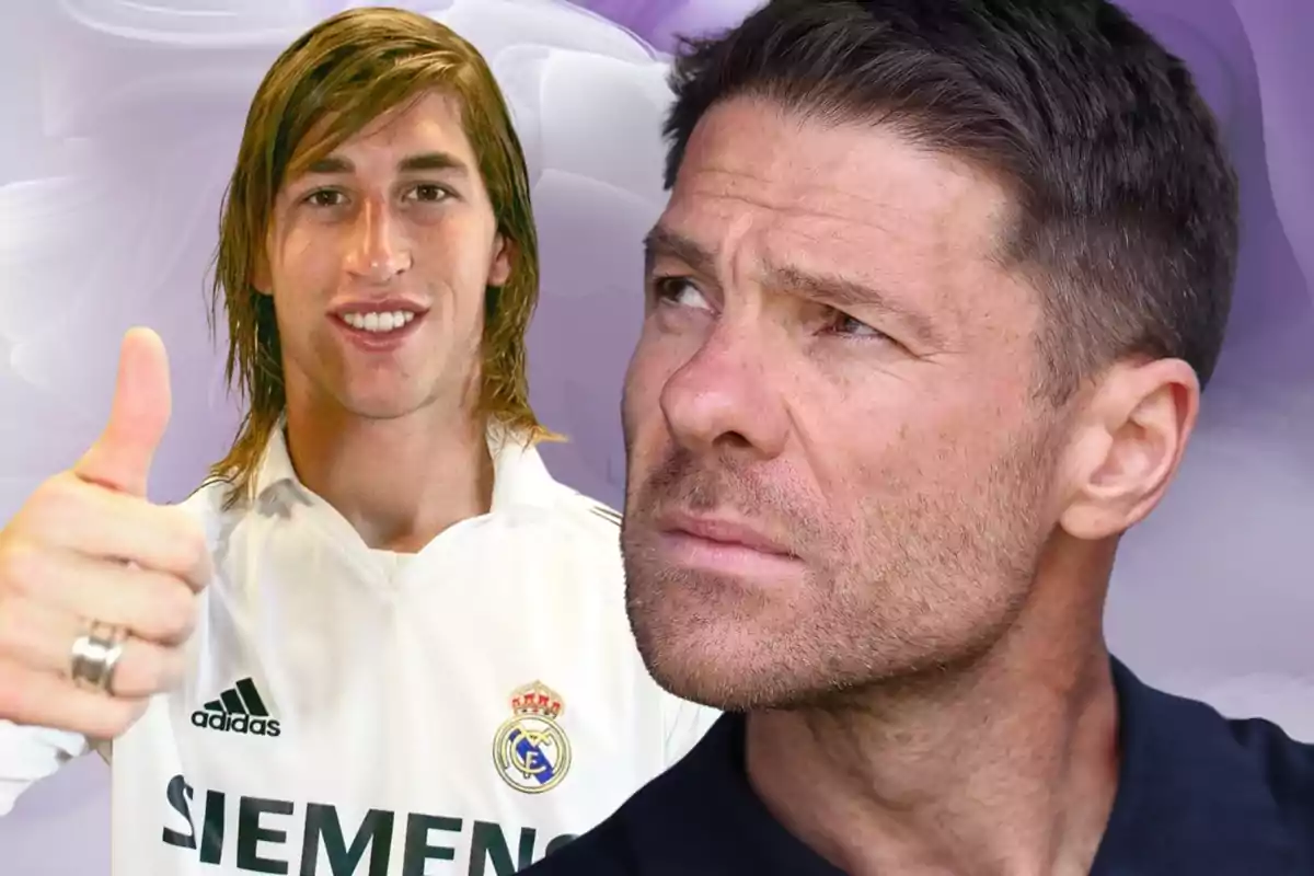 Dos hombres aparecen en la imagen, uno de ellos lleva una camiseta blanca del Real Madrid y muestra el pulgar hacia arriba mientras el otro mira pensativo hacia un lado
