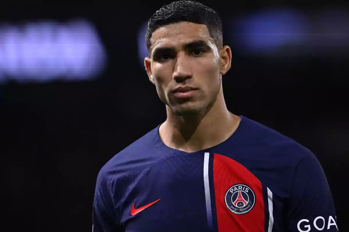 Achraf Hakimi in the blue and red uniform of Paris Saint-Germain in a stadium Achraf Hakimi in the blue and red uniform of Paris Saint-Germain in a stadium