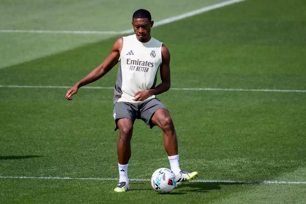 Soccer player training on the field wearing a Real Madrid uniform and controlling a ball Soccer player training on the field wearing a Real Madrid uniform and controlling a ball